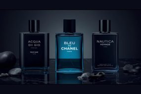 Flat lay of best summer colognes for men 2026 including Acqua di Gio Profumo, Bleu de Chanel and Nautica Voyage