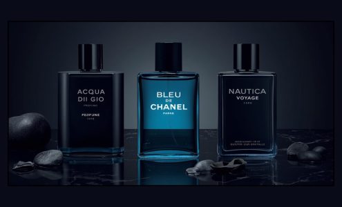 Flat lay of best summer colognes for men 2026 including Acqua di Gio Profumo, Bleu de Chanel and Nautica Voyage